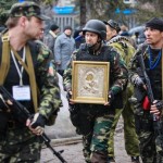 armed-pro-russian-protesters-escort-a-comrade-who-is-carrying-an-icon-which-they-said-was-found-in-the-seized-office-of-the-sbu-state-security-service-in-luhansk