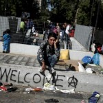 an-afghan-refugee-waits-to-be-transferred-from-victoria-square-to-an-indoor-stadium-in-athens