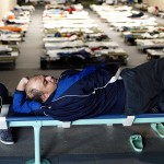 migrants-rests-at-an-improvised-temporary-shelter-in-a-sports-hall-in-hanau