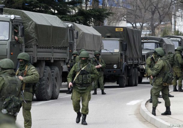 armed-servicemen-wait-near-russian-army-vehicles-outside-a-ukrainian-border-guard-post-in-the-crimean-town-of-balaclava