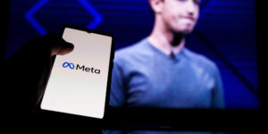 meta-logo-on-screen-and-mark-zuckerberg-is-a-chief-executive-officer-of-metaverse-in-background