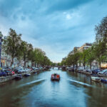 the-most-famous-canals-and-embankments-of-amsterdam-city-during-sunset-general-view-of-the-cityscape-and-traditional-netherlands-architecture