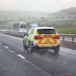 police-siren-flashing-blue-lights-on-motorway-in-bad-weather-con