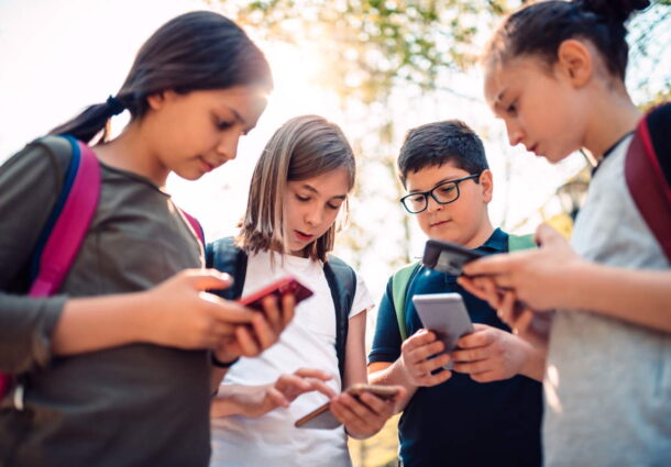 group-of-kids-playing-video-games-on-smart-phone-after-school