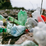 close-up-of-used-plastic-bottles-on-stone-beach-plastic-pollution-environmental-or-ecology-problem-concept